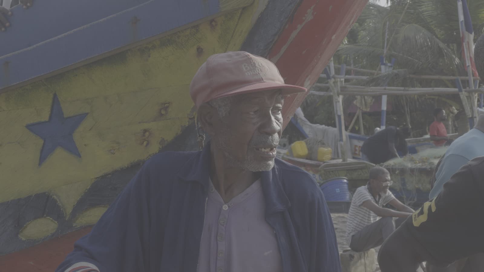 Fisherman beside a painted boat